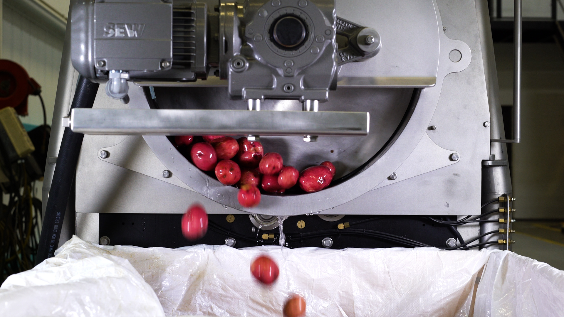 A Vanmark commercial potato peeler machine in action. A Vanmark commercial potato peeler machine in action.